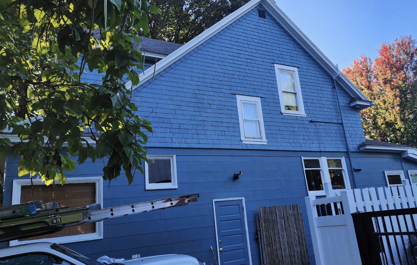 Freshly painted navy blue two-story exterior after Noe's Painting completed the job