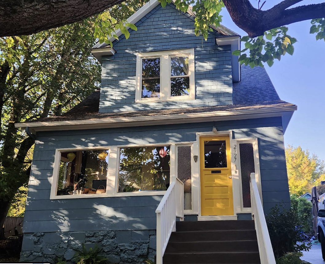 Finished navy blue exterior with yellow front door after painting by Noe's Painting