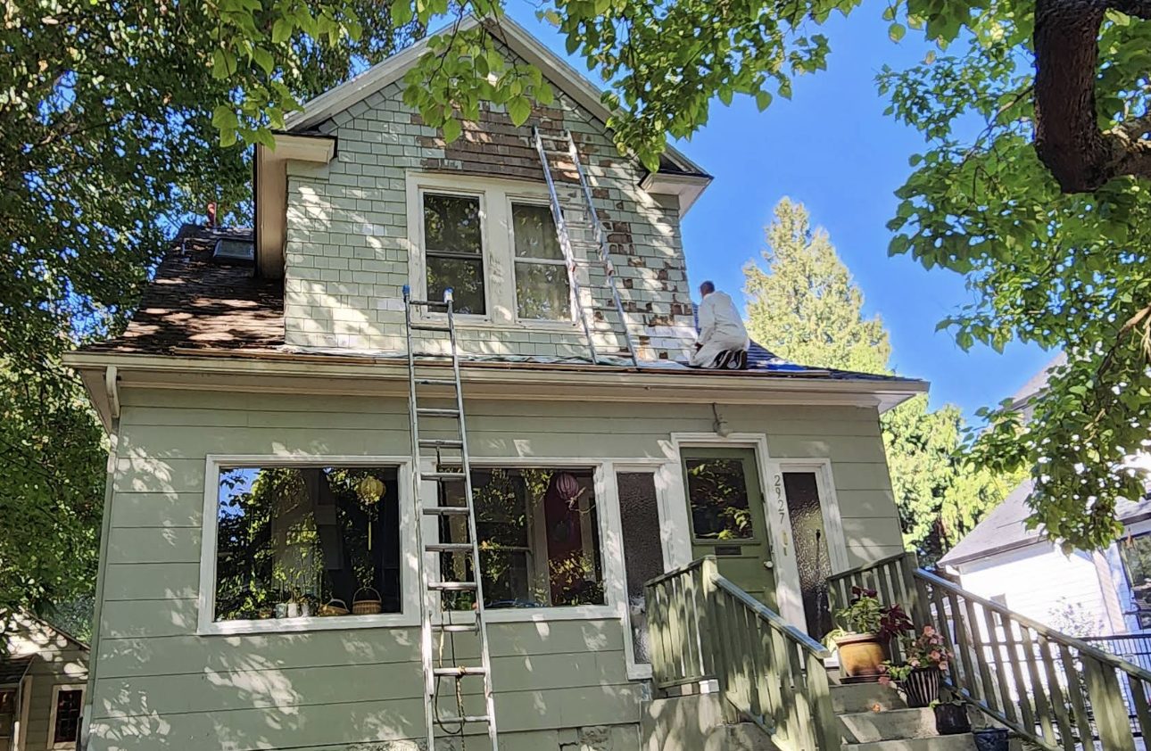 House exterior mid-repaint before Noe's Painting finished the job