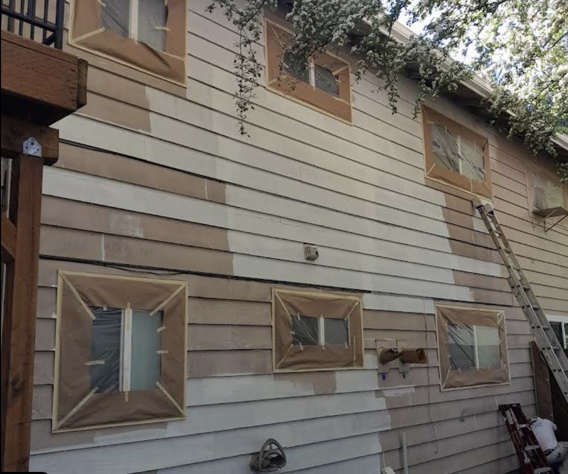 Two-tone, partially painted siding before Noe's Painting completed the job