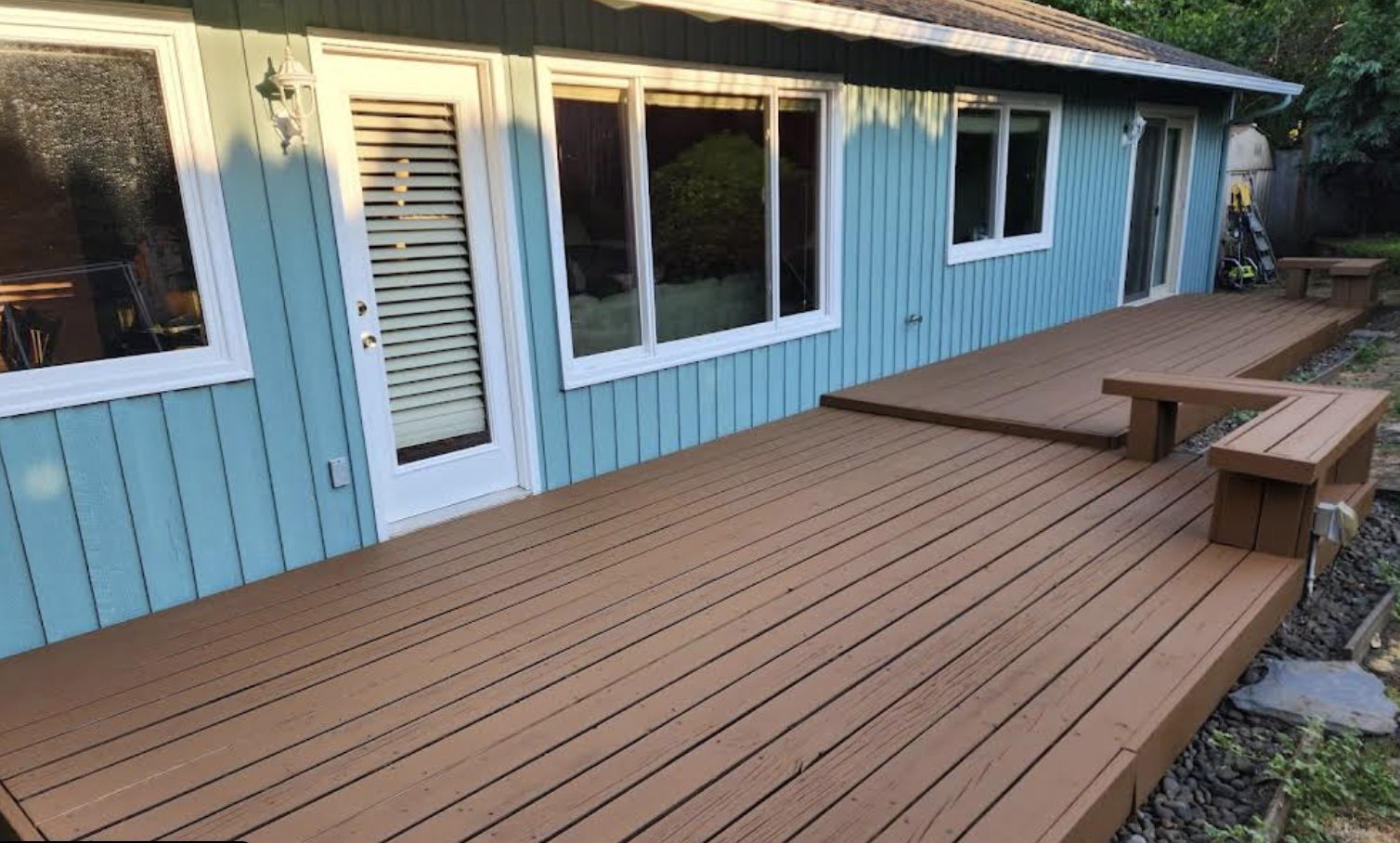 Light blue house exterior with deck painted by Noe's Painting