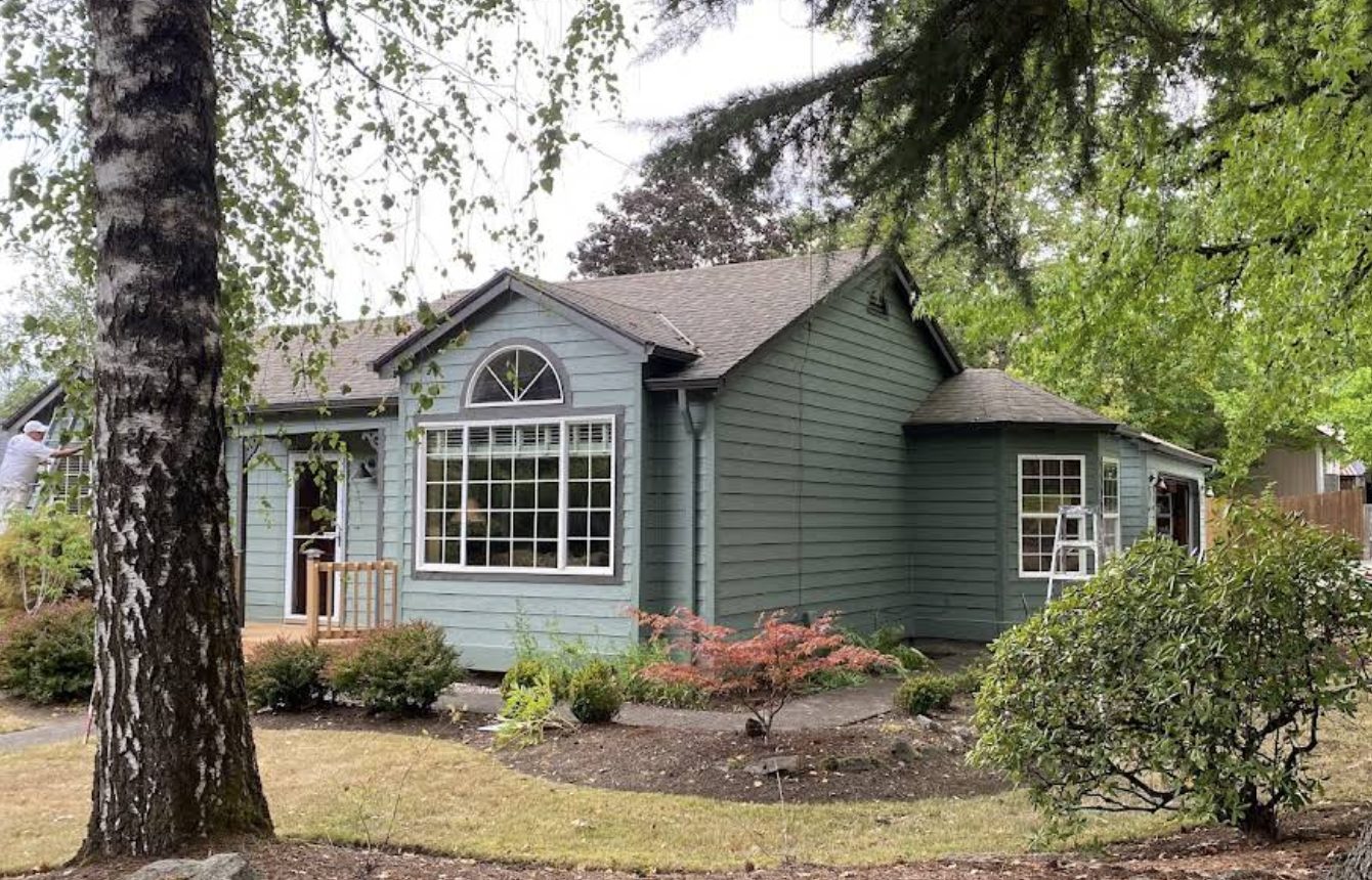 Sage green house exterior with landscaping painted by Noe's Painting